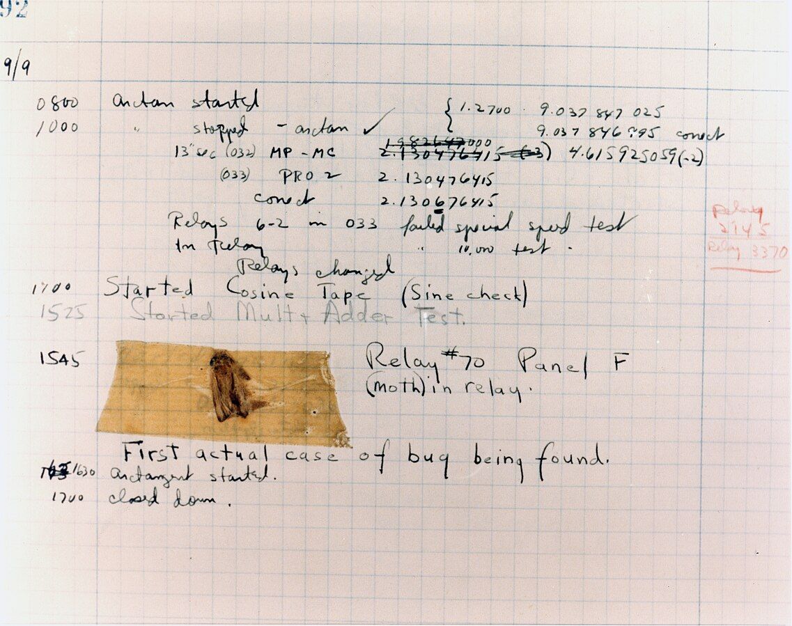A moth taped to a written report that says "First actual case of bug being found" and (incorrectly) dated 1945.